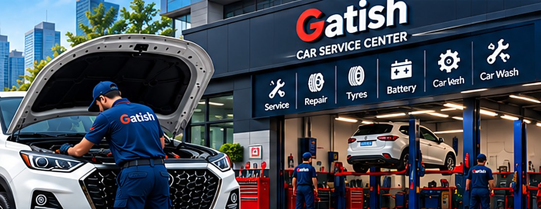 A mechanic at a white SUV in front of a car service workshop